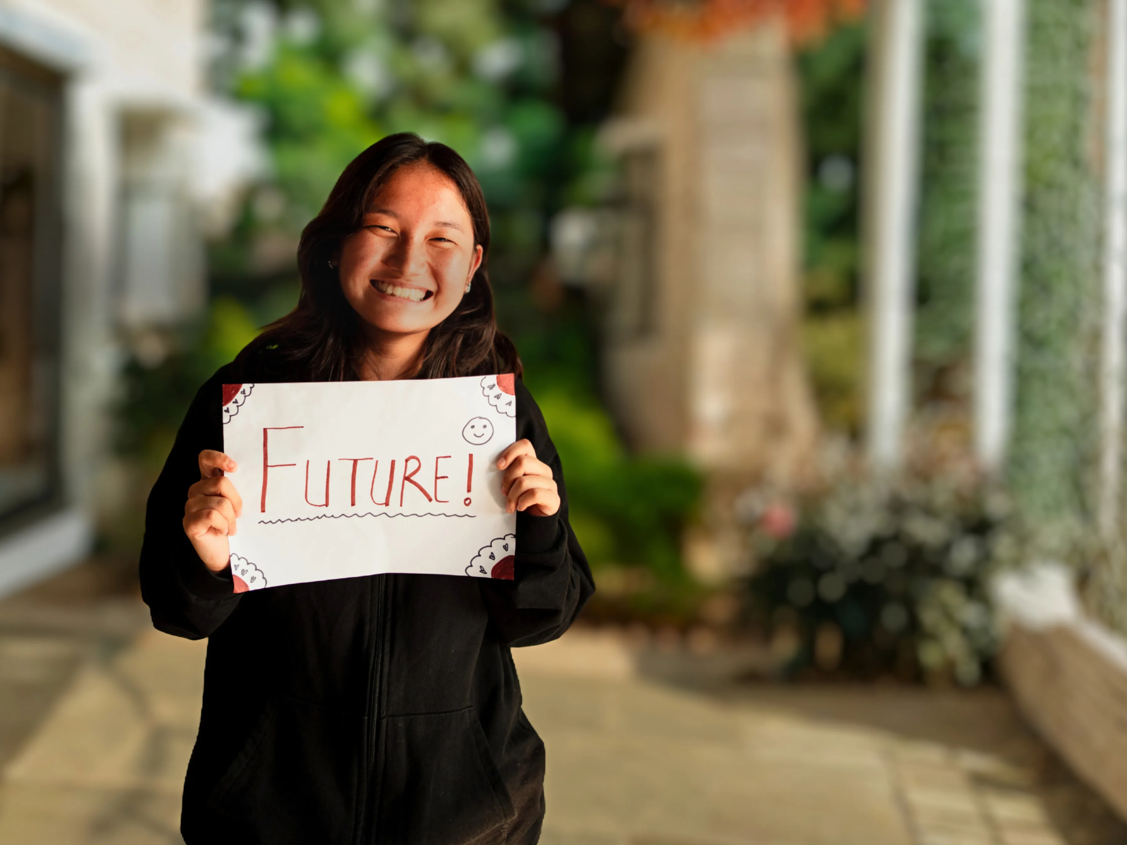 Image of female student from India holding future sign