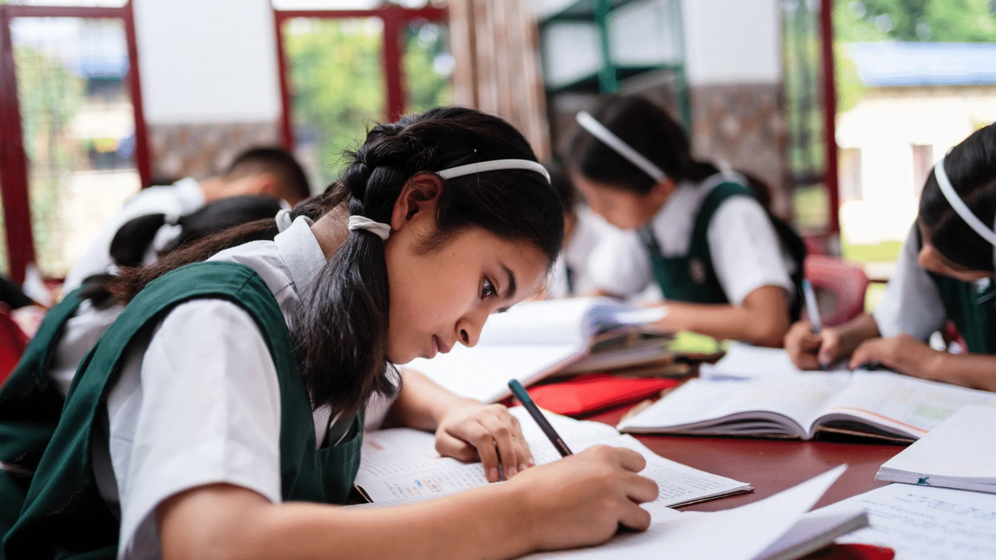 Girls writing in classroom at Pestalozzi International India