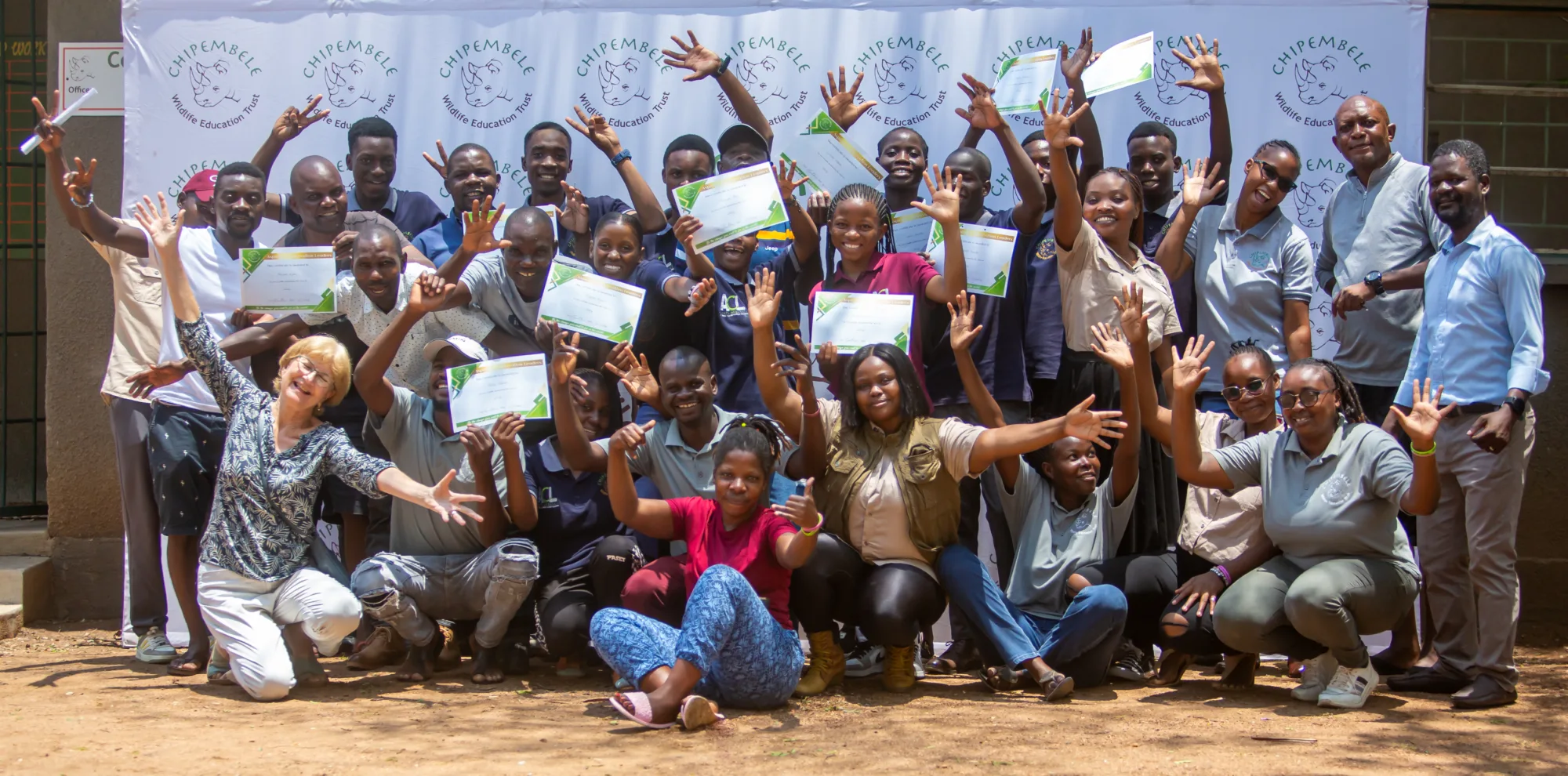 A group of children graduating from Pestalozzi Zambia and cheering