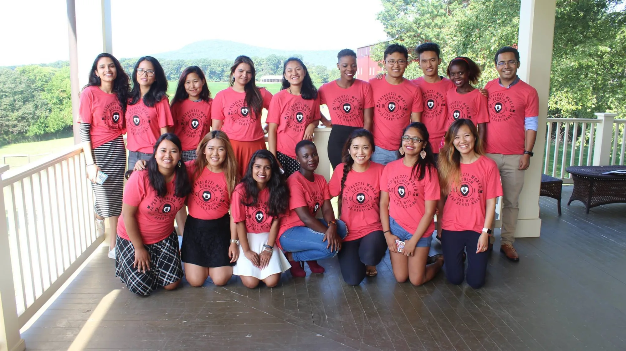 A group of Pestalozzi Alumni from all over the world all wearing pink shirts