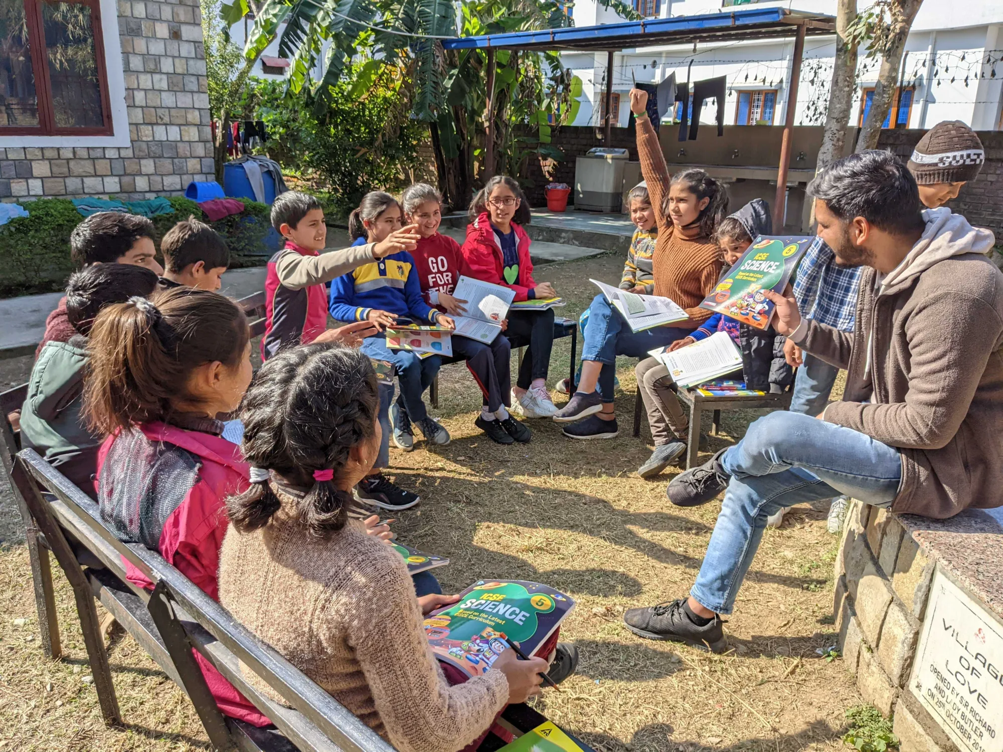 Children in a reading class outside in India