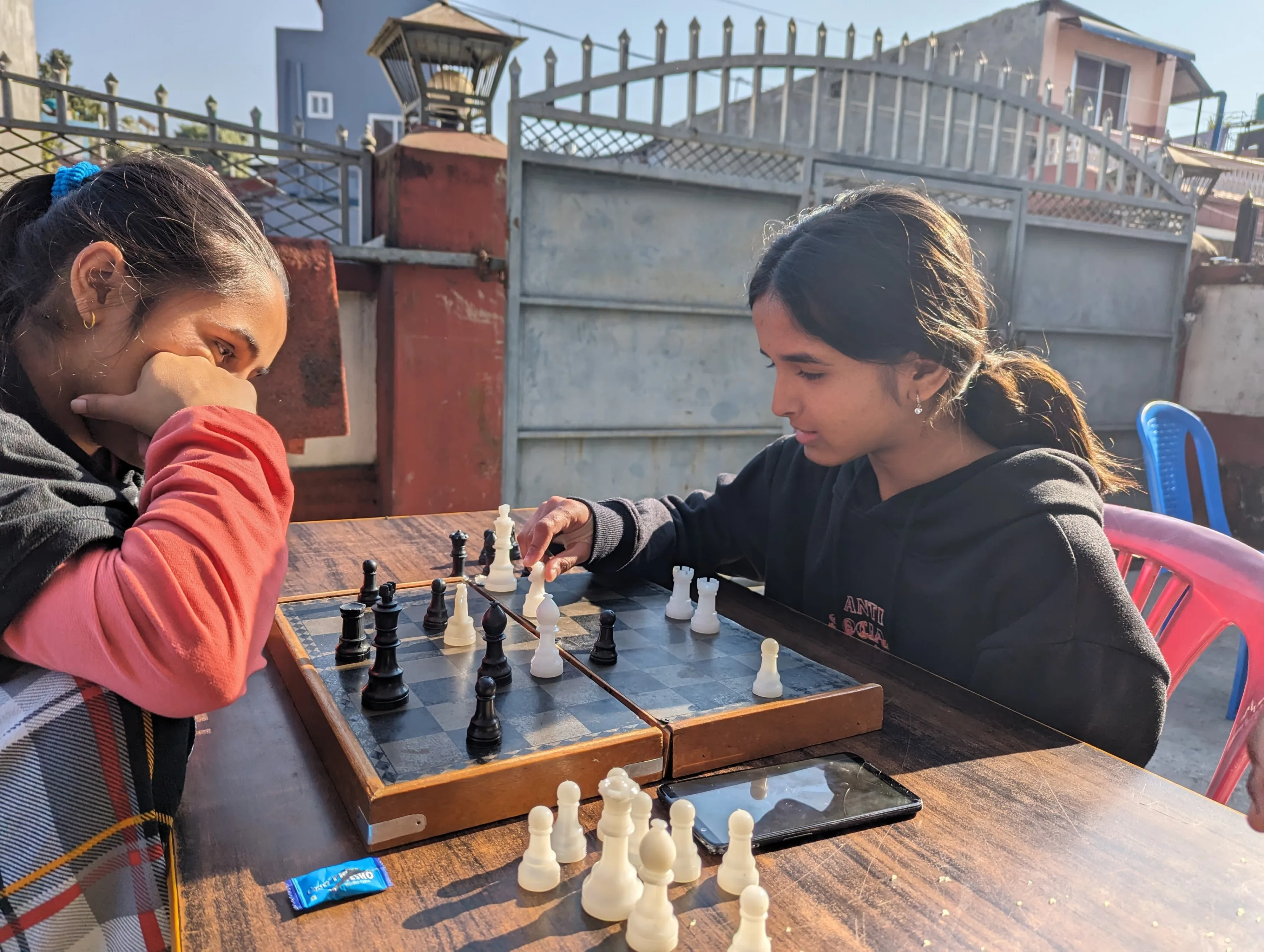 Two Pestalozzi school girls playing chess in Nepal