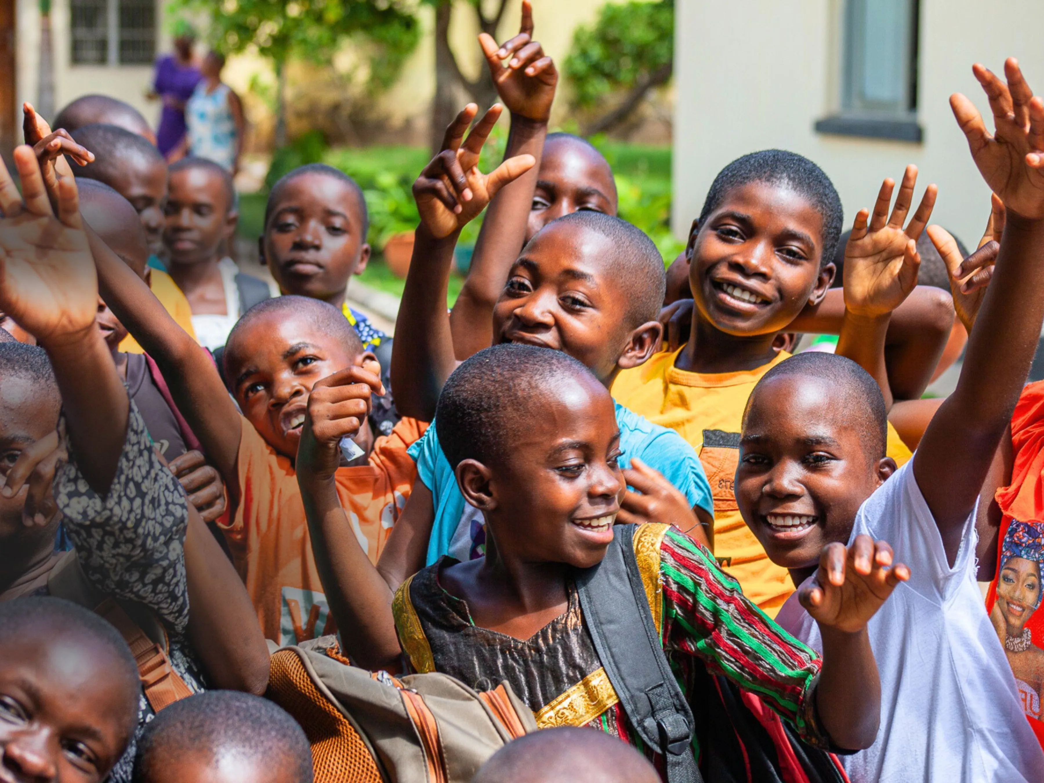 Image of new students and current students greeting one another in Pestalozzi Zambia.