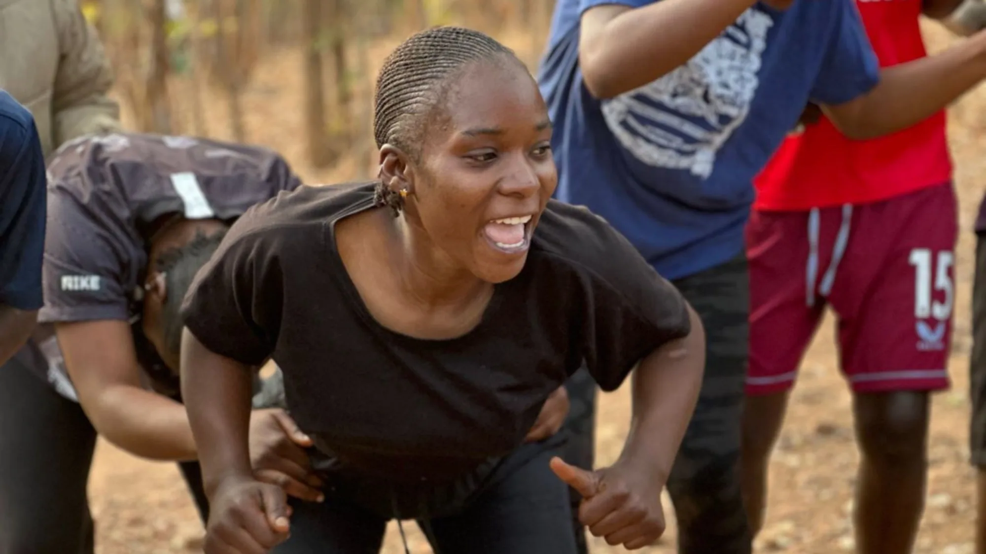 A female trainee at the Skillshub Mindset camp dancing and singing.