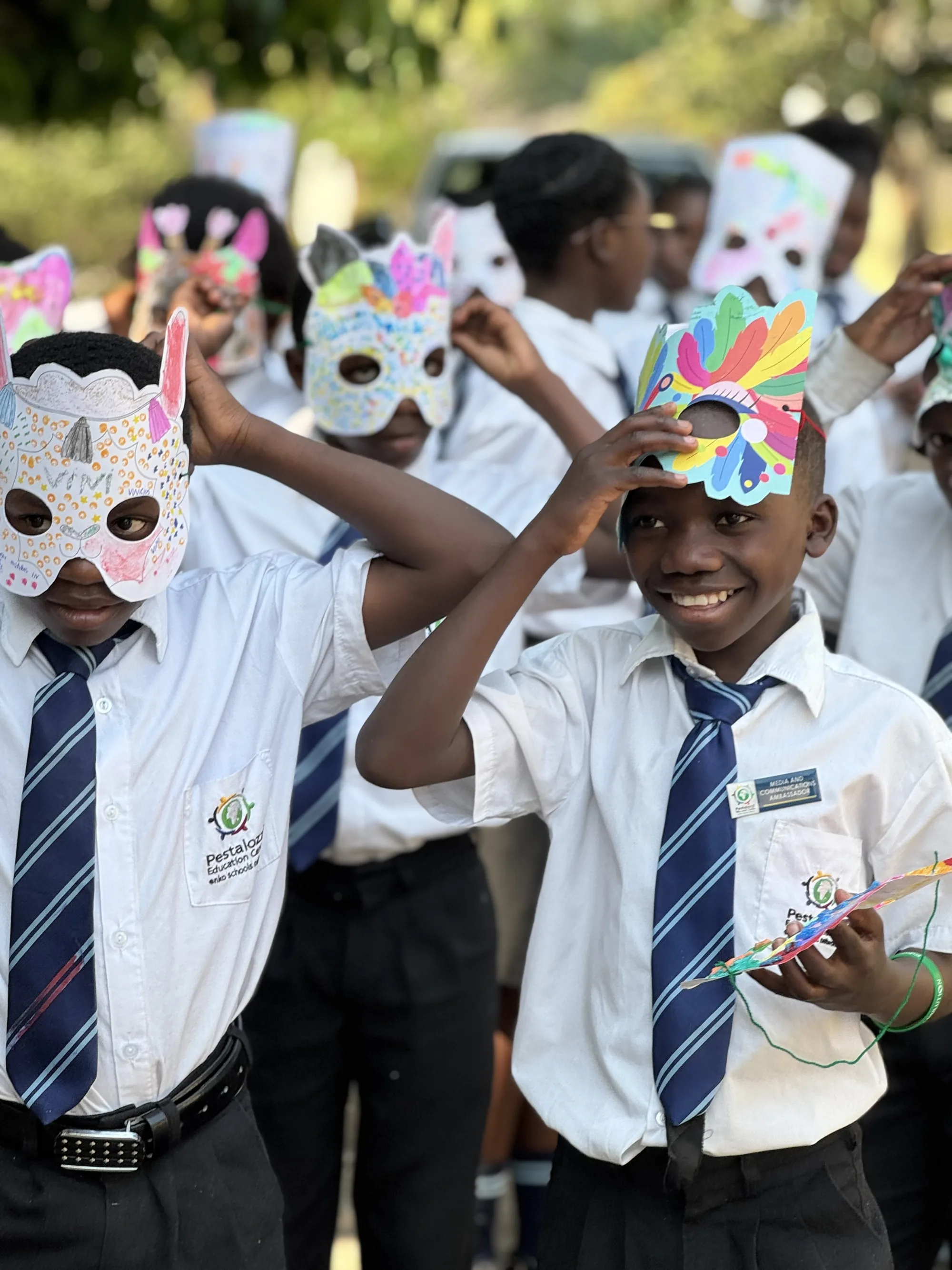 A group of students happy and dancing in their own face masks