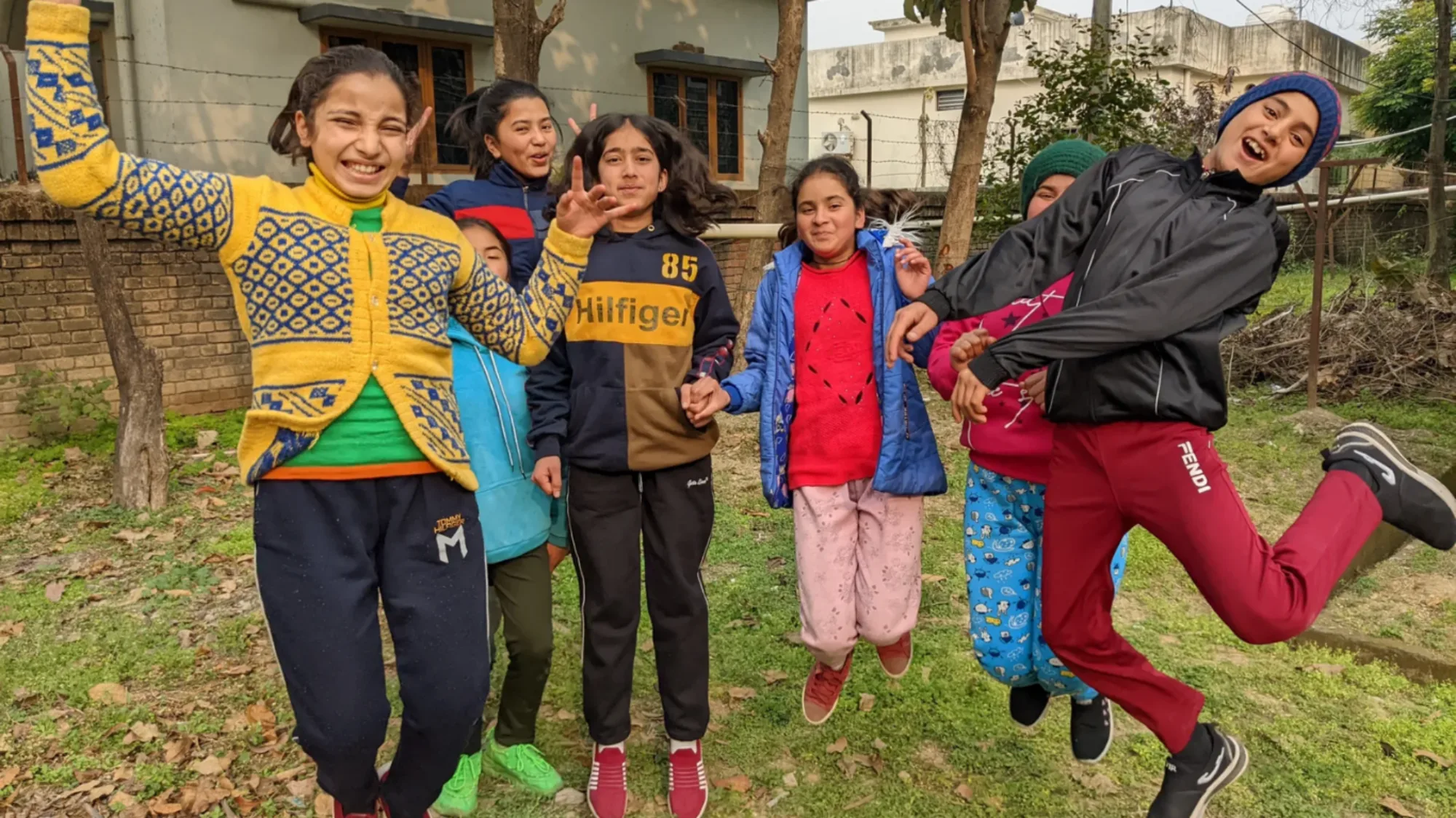 Students from Pestalozzi India jumping outside