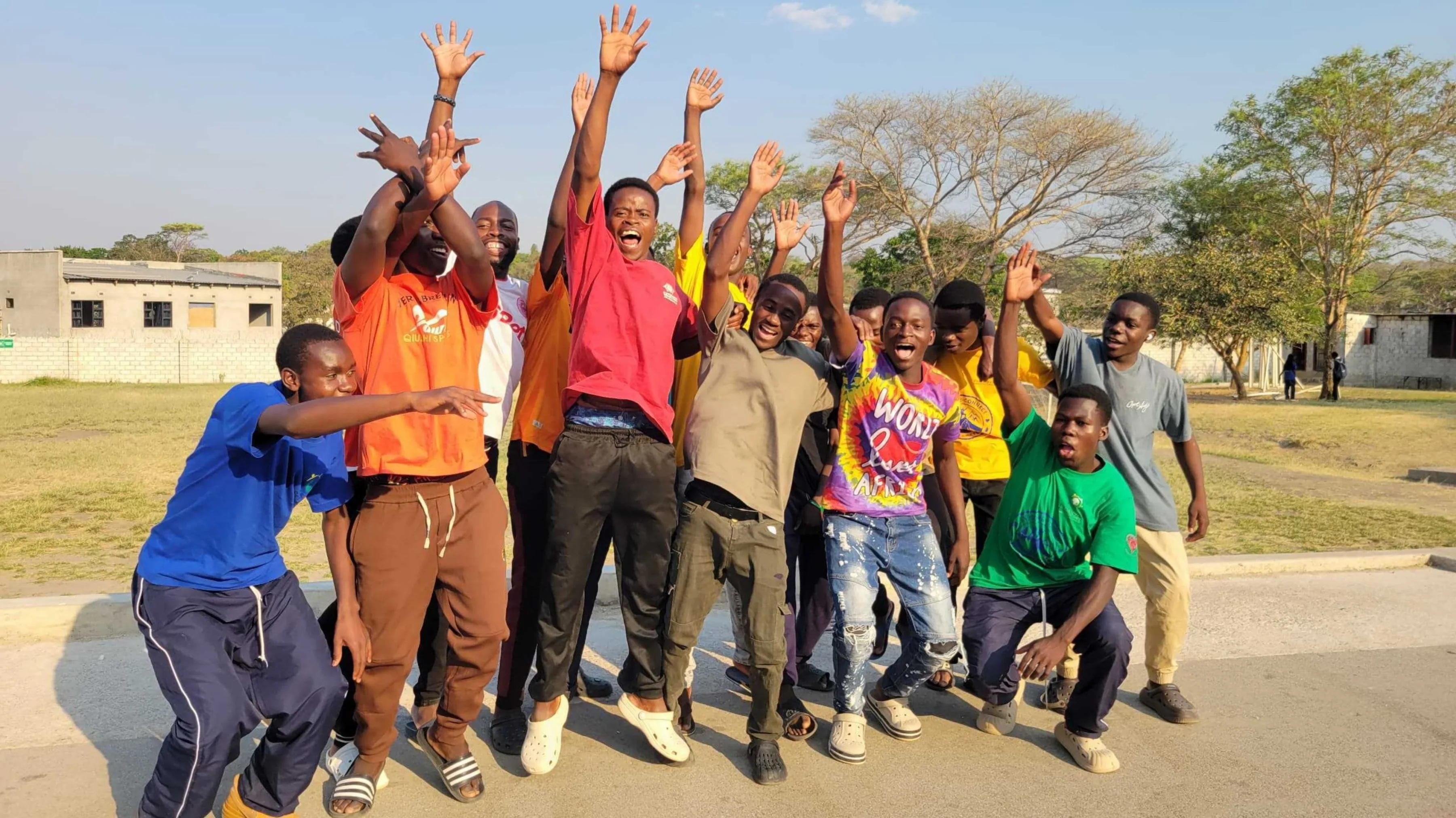 Group of male students happily jumping