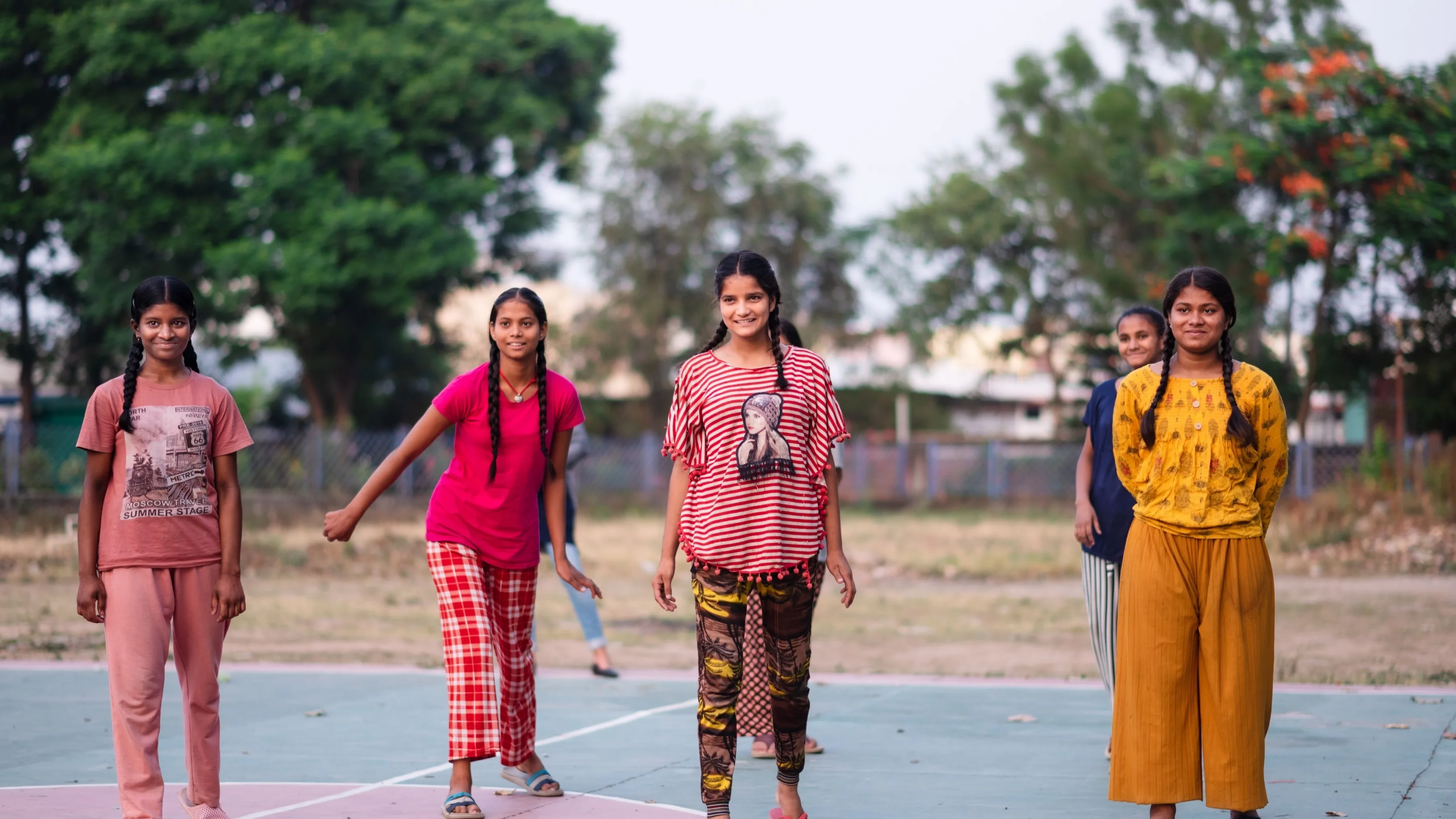 Image of a group of smiling females students in playground - India