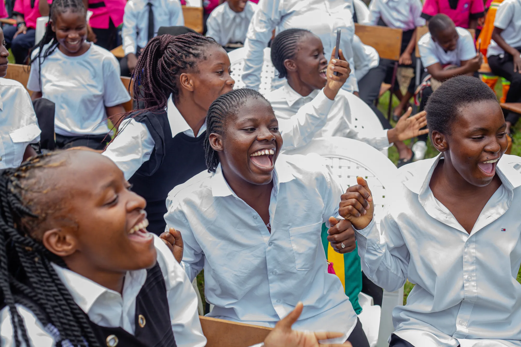 Group of females students from or campus in Zambia seated as they watch the presentation that has mad each of them laugh out loud