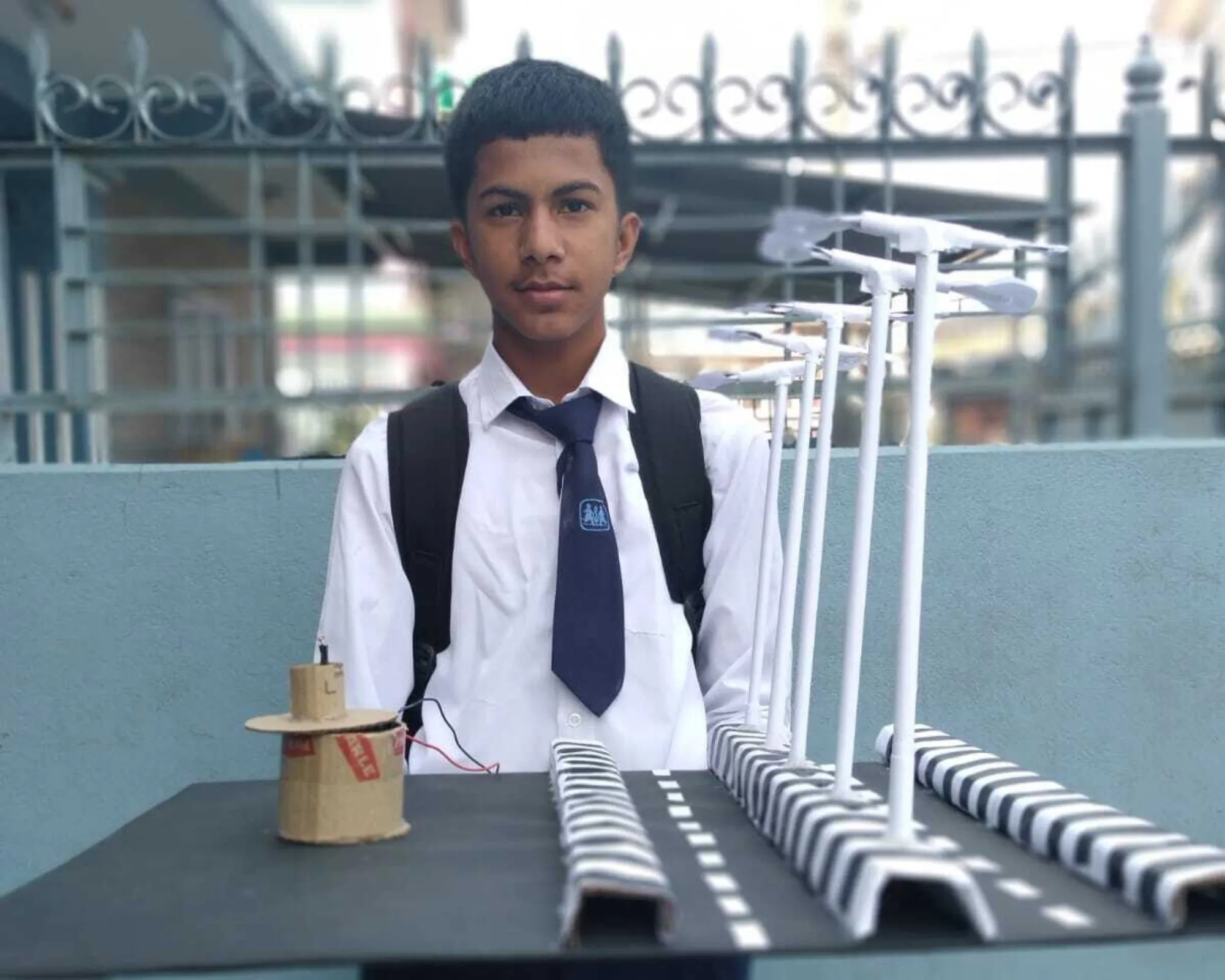 Pestalozzi India scholar Bishal standing behind his project work